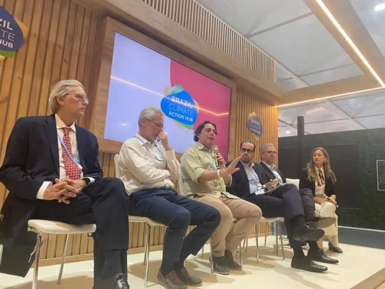 Grupo reunido na 27ª Conferência das Nações Unidas sobre Mudanças Climáticas, falando sobre a regulação do mercado de carbono.
