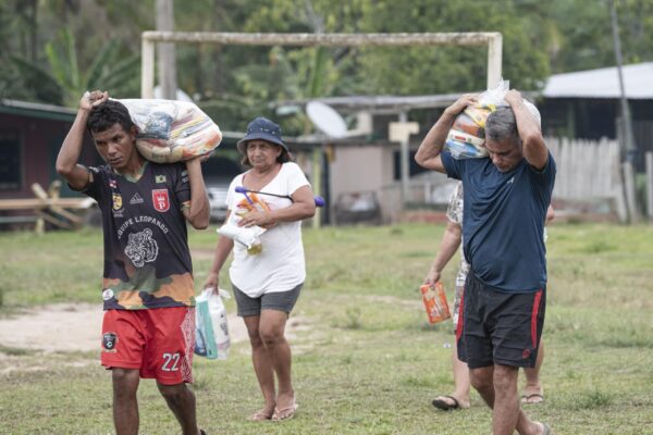 Comunitários recebendo cestas básicas que foram doadas através da Aliança Amazônia Clima, apoiada pela Fundação Amazônia Sustentável (FAS).